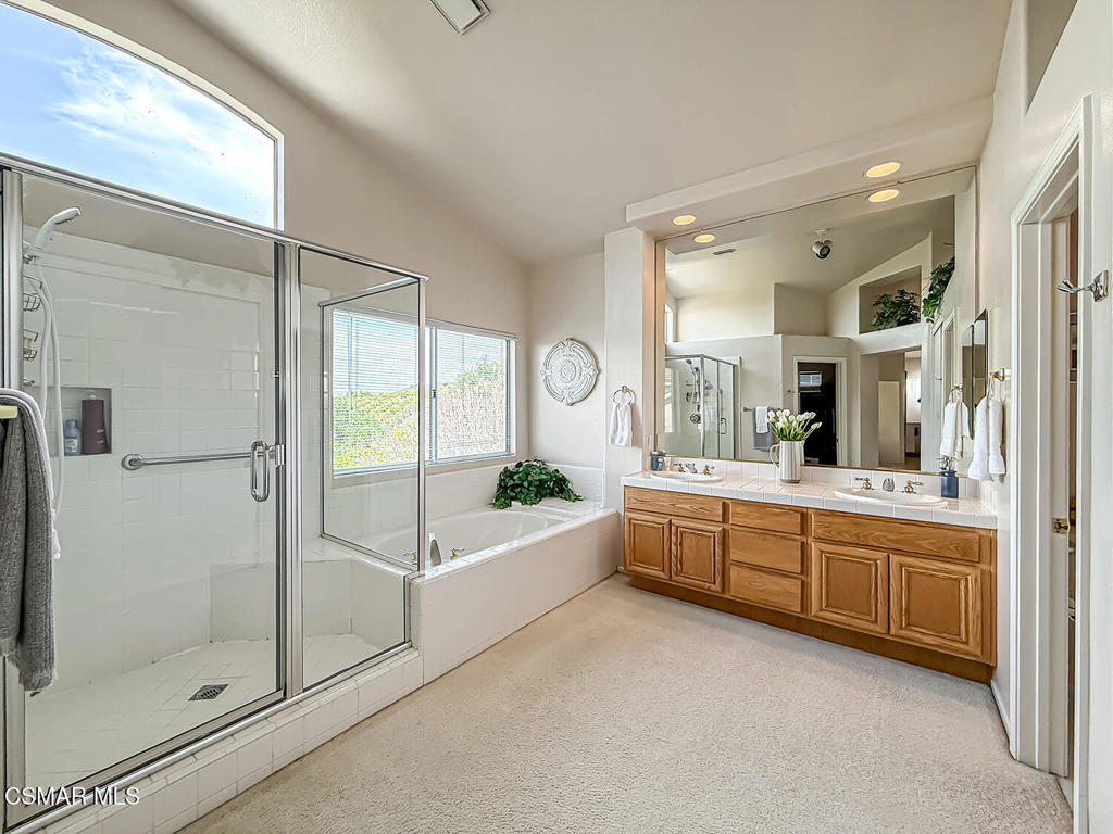 260 Sycamore Ridge Street Simi Valley, CA 93065 - Photo 36 of 58 a large white bathroom with a large tub and shower