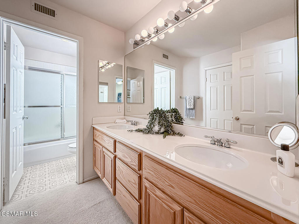 260 Sycamore Ridge Street Simi Valley, CA 93065 - Photo 47 of 58 a bathroom with a double vanity sink and a mirror