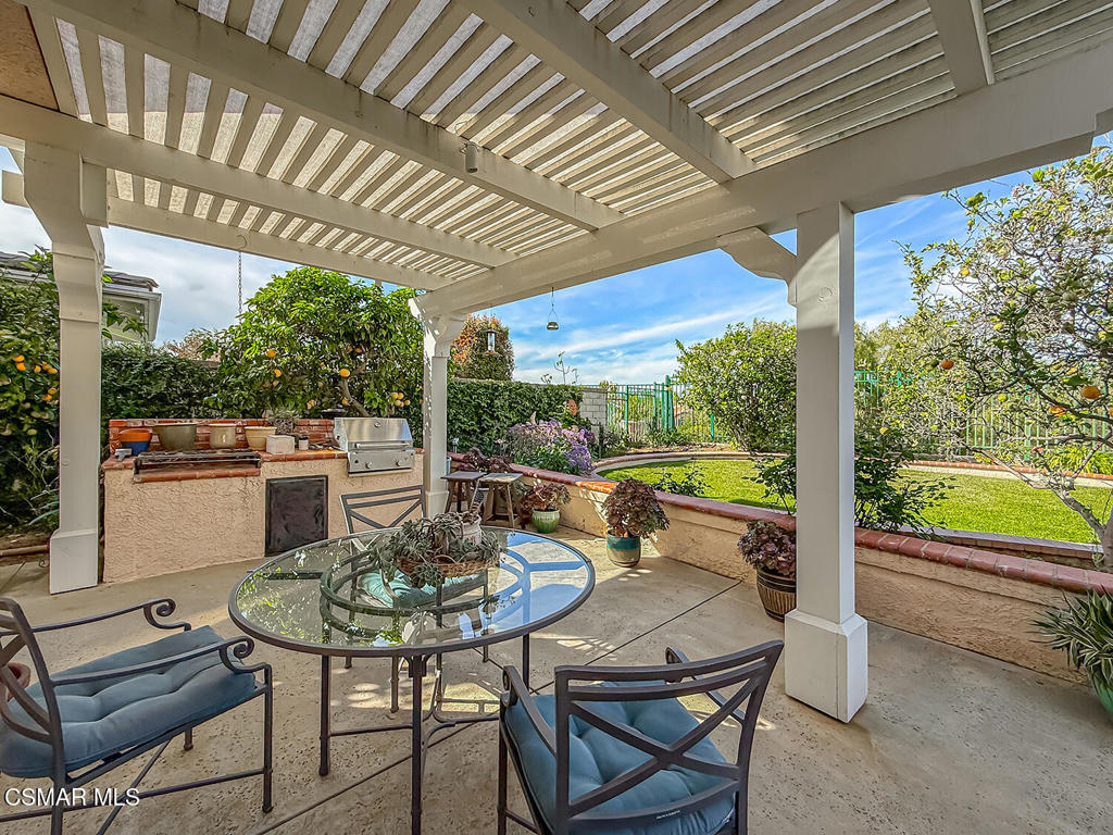 260 Sycamore Ridge Street Simi Valley, CA 93065 - Photo 52 of 58 a view of a patio with a table chairs and a couple of flower plants