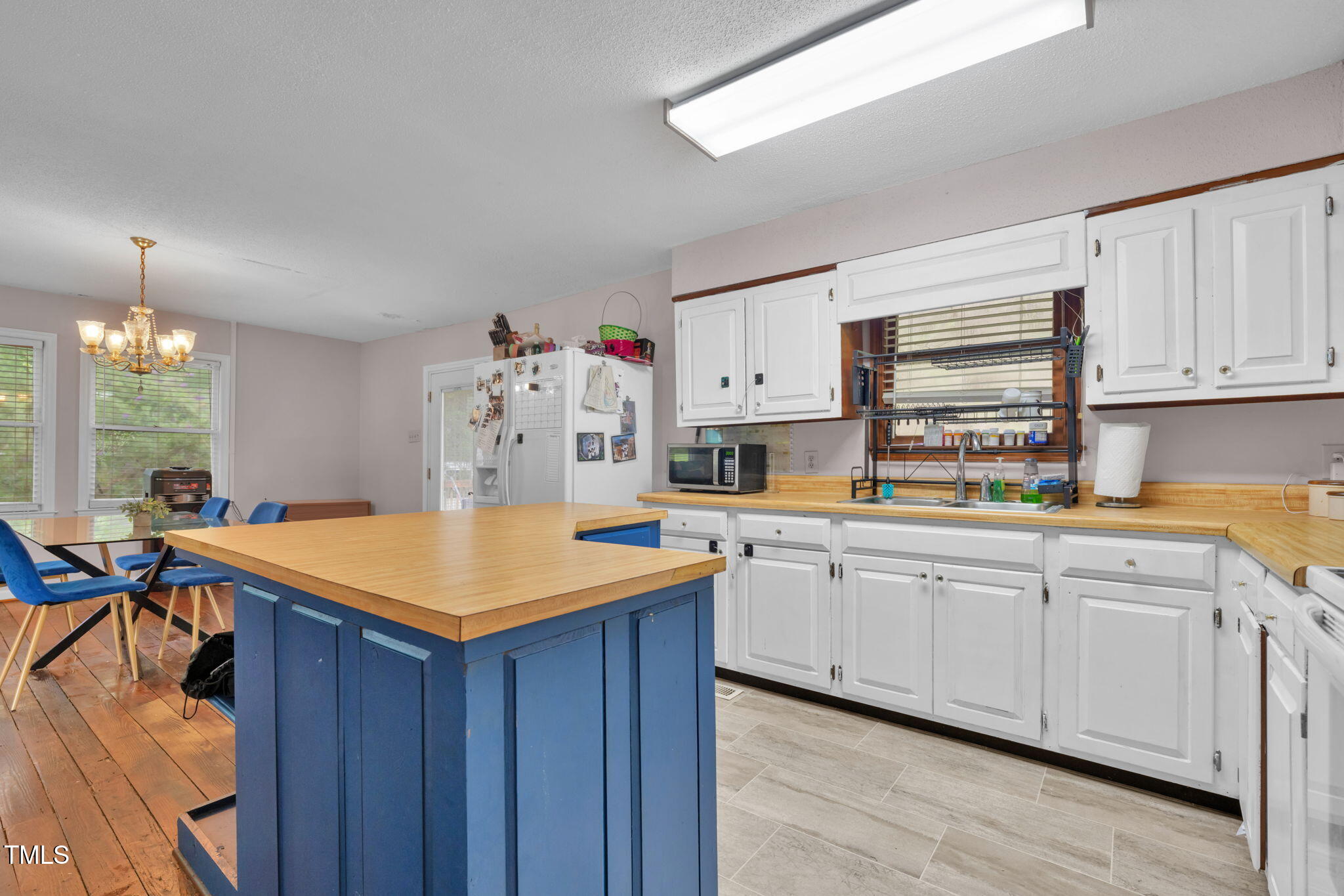 720 Division Street Norlina, NC 27563 - Photo 12 of 38 a kitchen with stainless steel appliances granite countertop a table chairs sink and cabinets