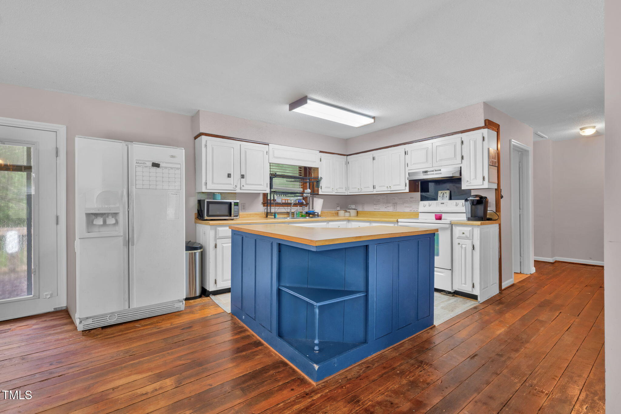 720 Division Street Norlina, NC 27563 - Photo 13 of 38 a kitchen with wooden floors and wooden cabinets