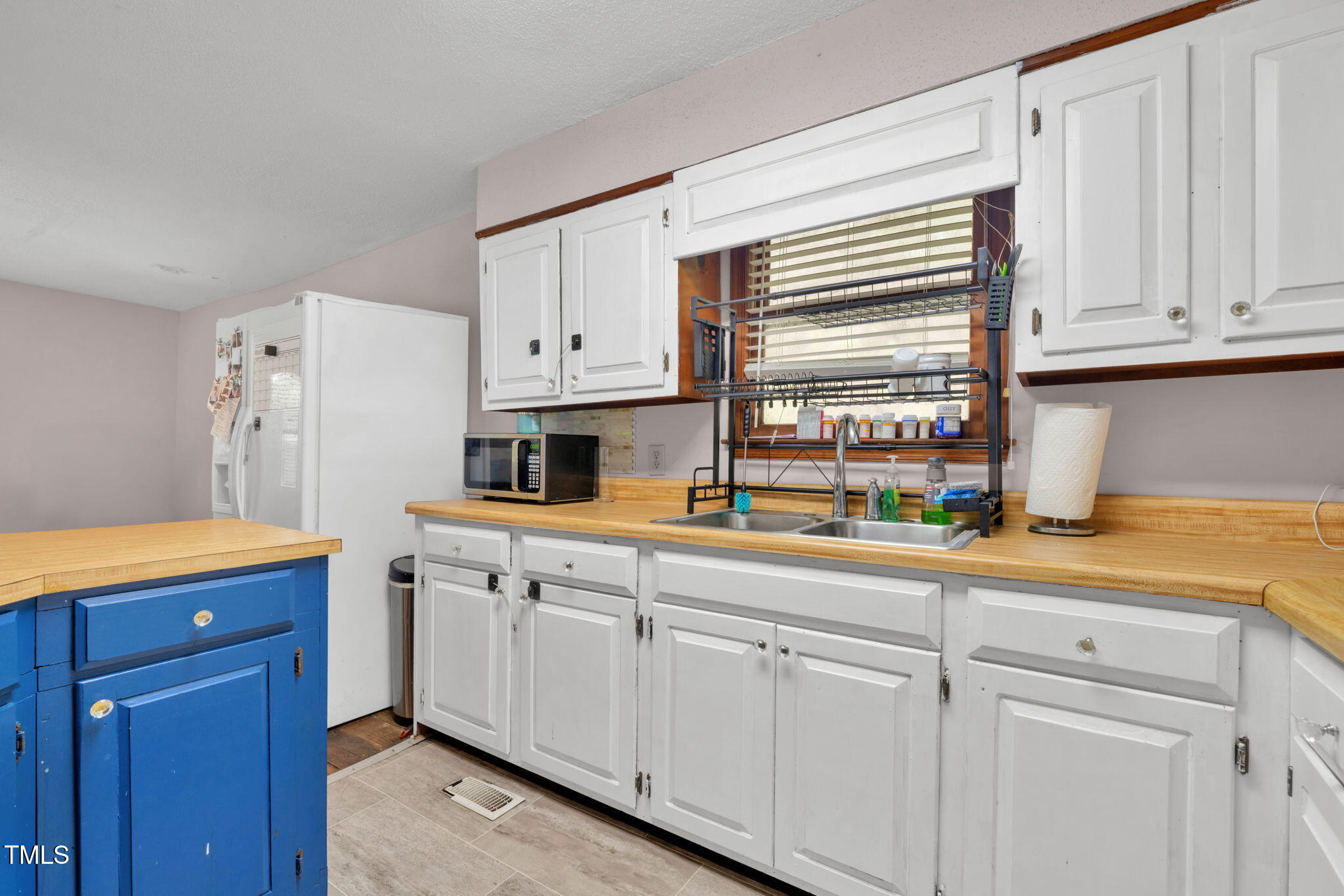 720 Division Street Norlina, NC 27563 - Photo 14 of 38 a kitchen with granite countertop white cabinets and a window