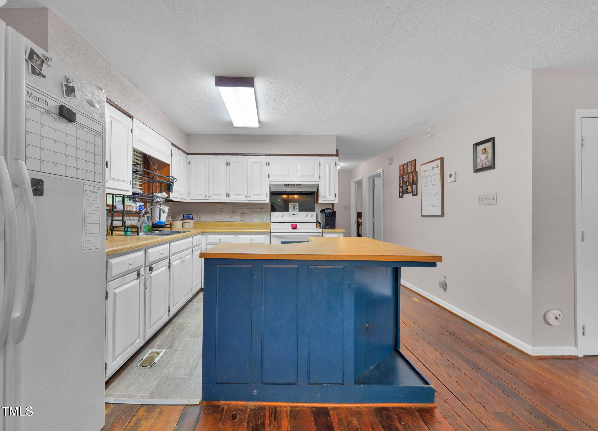 720 Division Street Norlina, NC 27563 - Photo 15 of 38 a kitchen with wooden floors and wooden cabinets