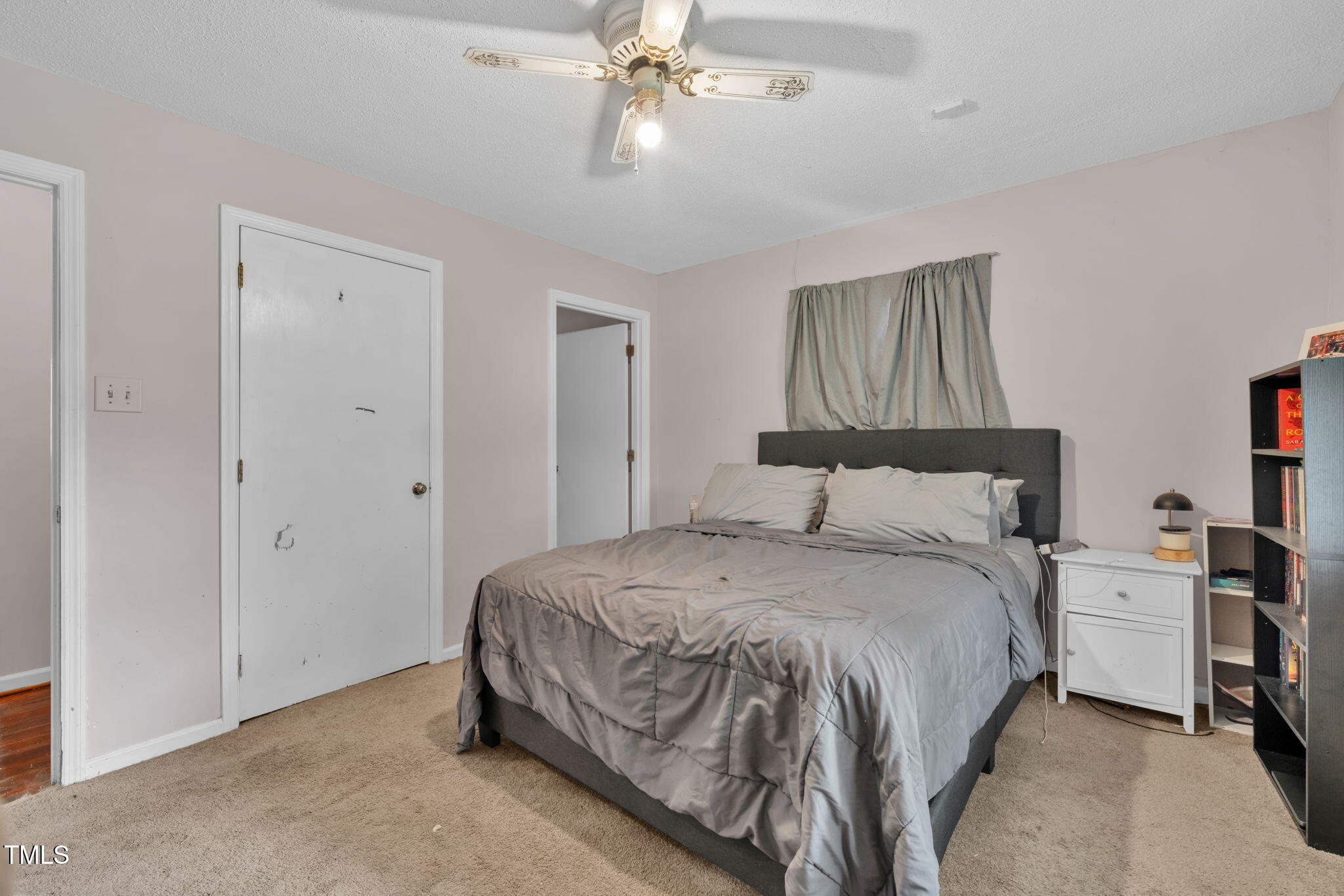720 Division Street Norlina, NC 27563 - Photo 17 of 38 a bedroom with a bed and a chandelier