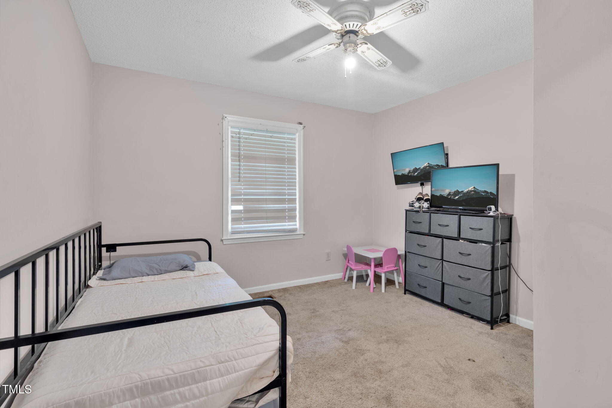 720 Division Street Norlina, NC 27563 - Photo 20 of 38 a bedroom with a bed and a chandelier