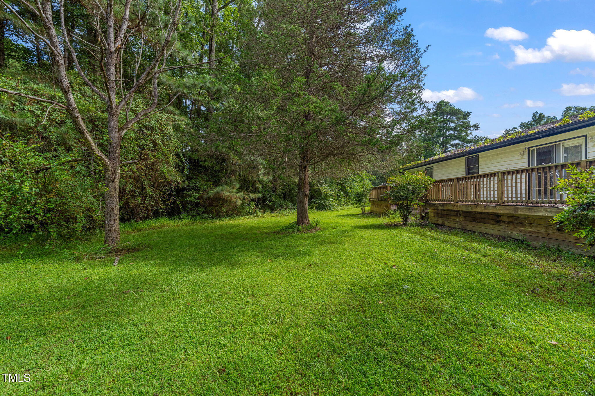 720 Division Street Norlina, NC 27563 - Photo 28 of 38 a view of a backyard with wooden fence and trees