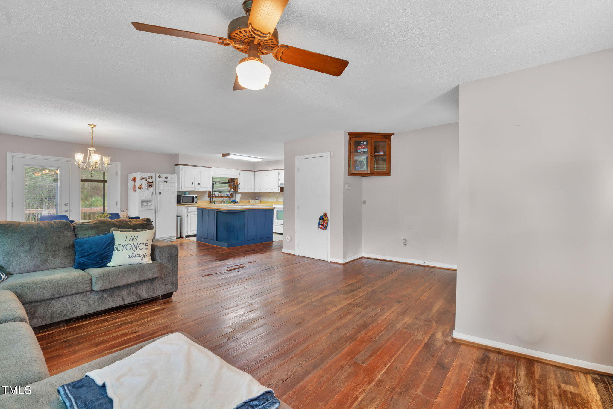 720 Division Street Norlina, NC 27563 - Photo 6 of 38 a living room with kitchen island furniture and a ceiling fan
