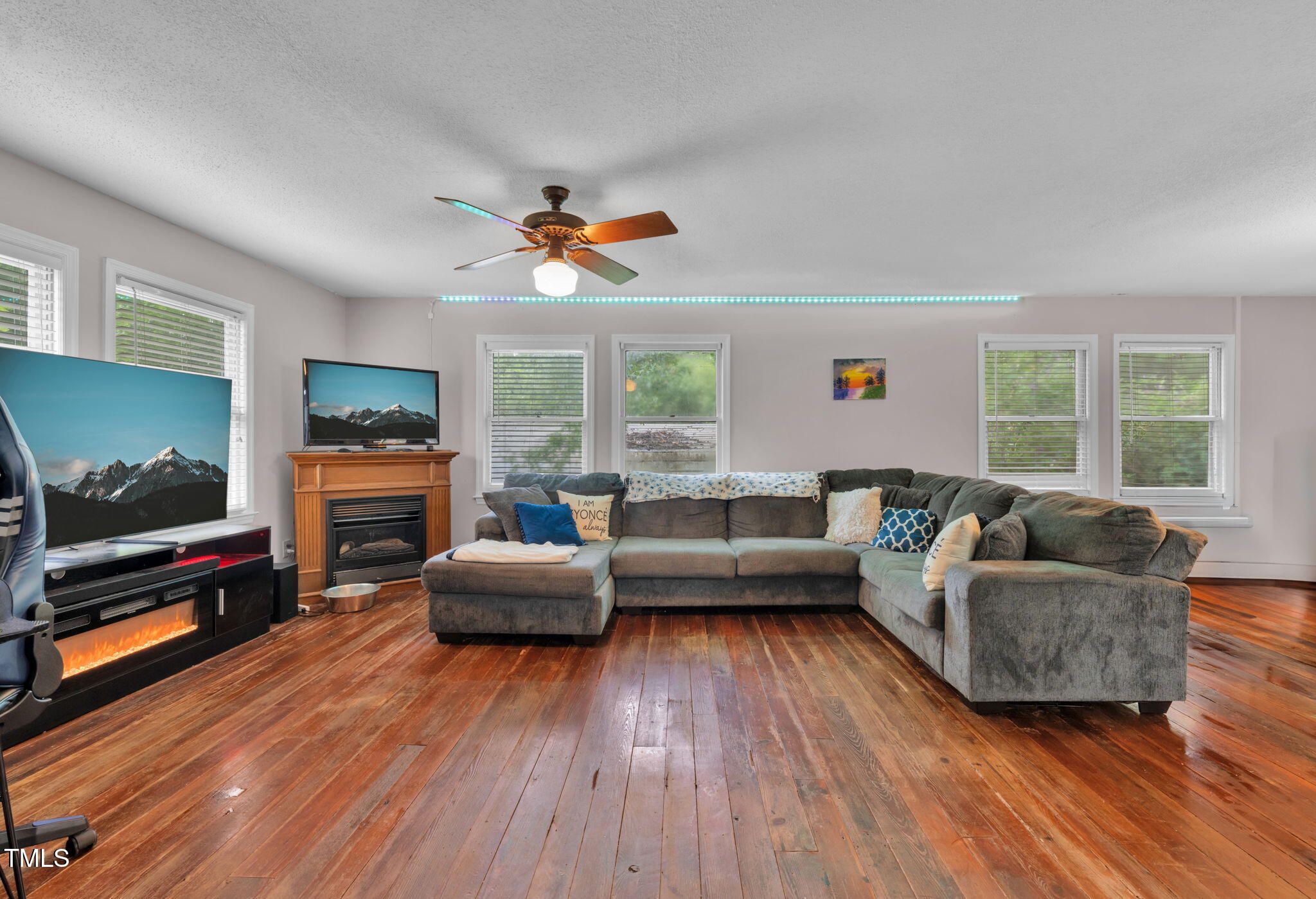 720 Division Street Norlina, NC 27563 - Photo 7 of 38 a living room with fireplace furniture and a flat screen tv