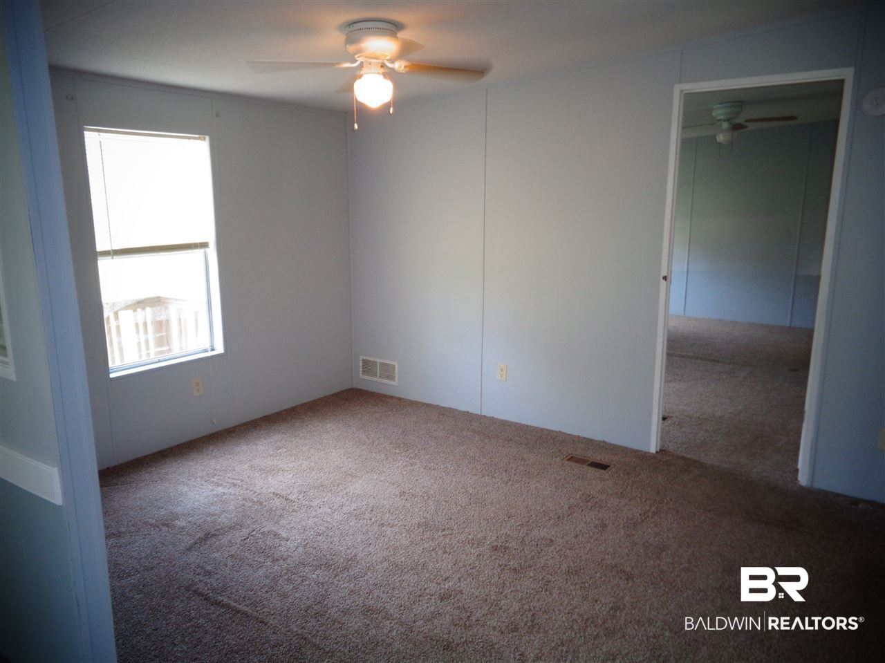 21535 A Glass And Spivey Road Robertsdale, AL 36567 - Photo 7 of 32 13x10. Carpet. Ceiling fan/light.