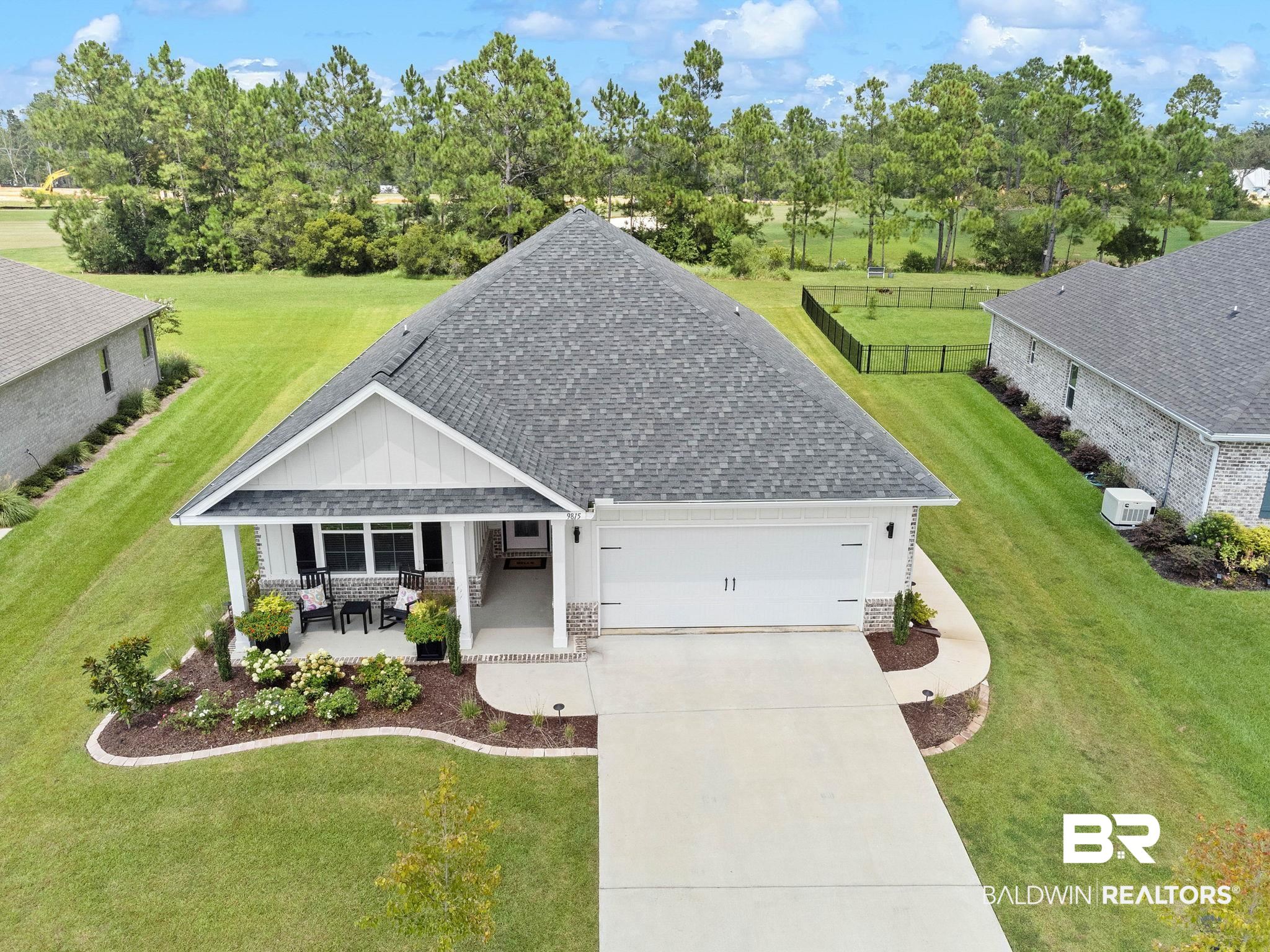 9815 Lakeview Drive Foley, AL 36535 - Photo 80 of 100 View of front of property with a front lawn, covered porch, central AC, and a garage