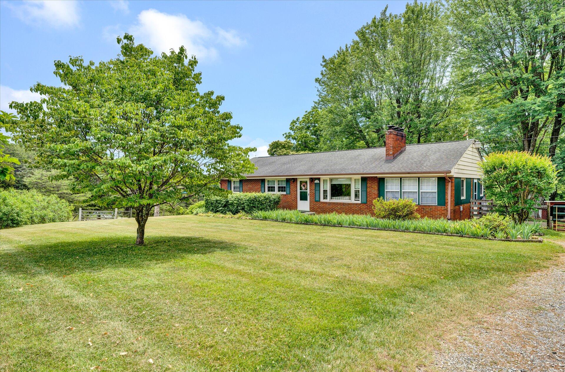 2407 White House Road Moneta, VA 24121 - Photo 1 of 52 a front view of a house with a yard