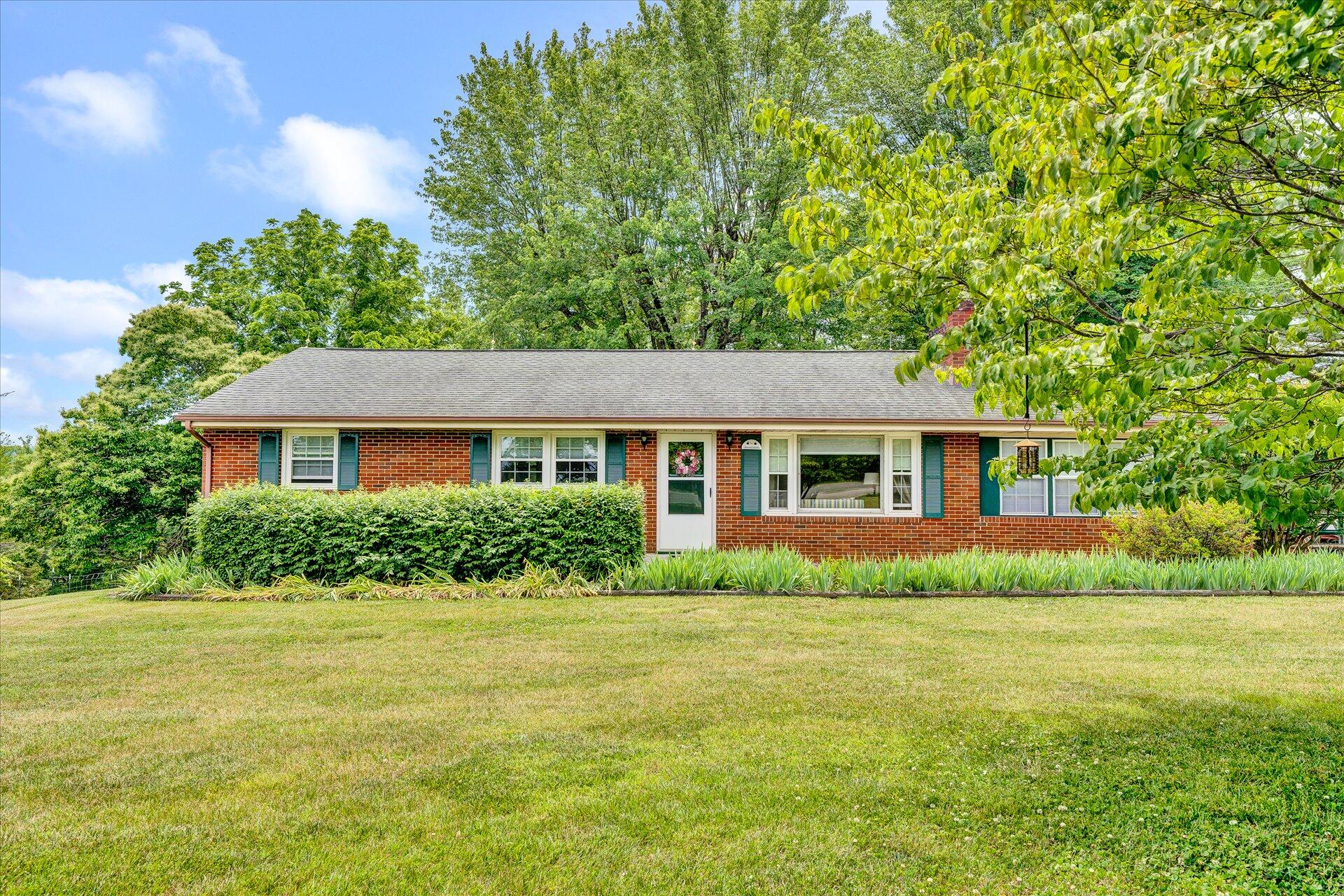 2407 White House Road Moneta, VA 24121 - Photo 2 of 52 a front view of a house with a yard