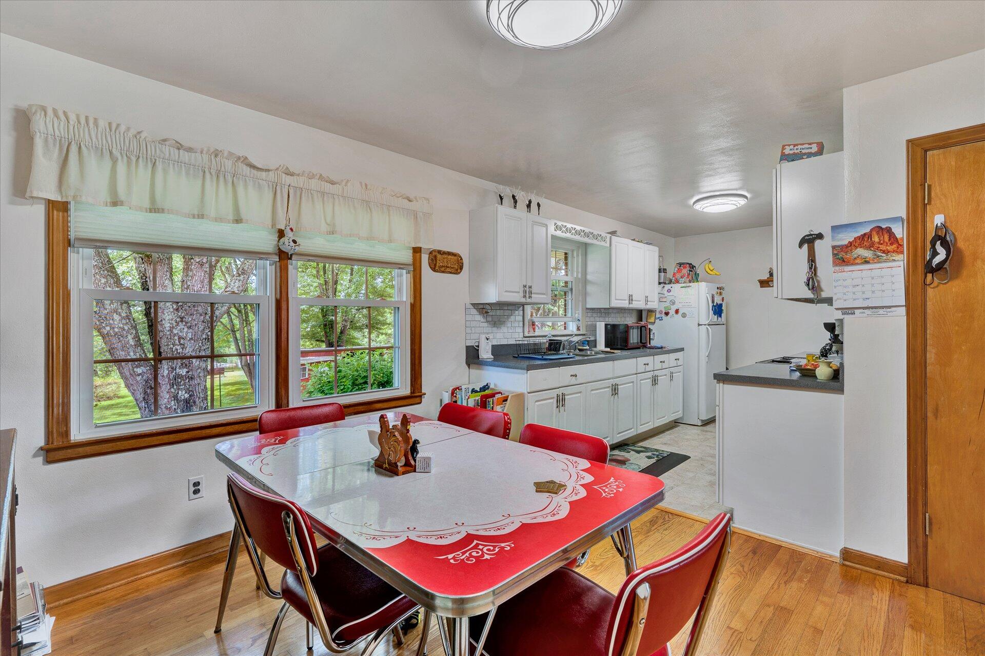 2407 White House Road Moneta, VA 24121 - Photo 12 of 52 a living room with kitchen island a table and chairs in it