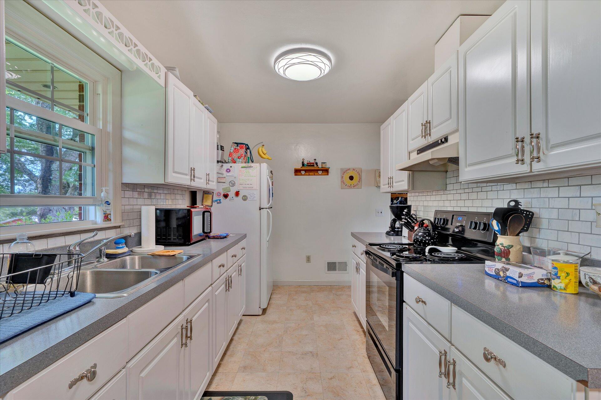 2407 White House Road Moneta, VA 24121 - Photo 13 of 52 a kitchen with a sink stove top oven and refrigerator