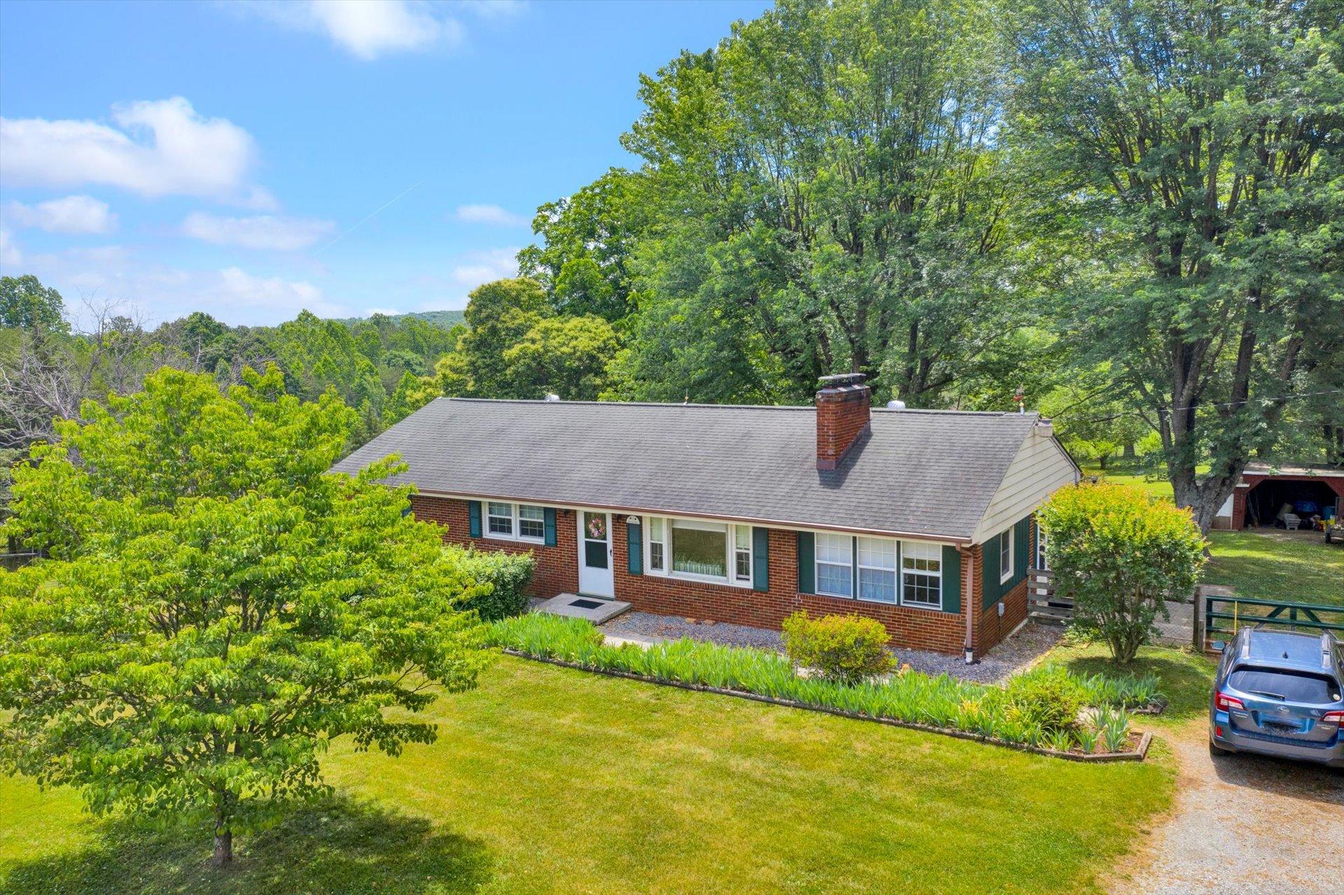 2407 White House Road Moneta, VA 24121 - Photo 35 of 52 a aerial view of a house with swimming pool and large trees