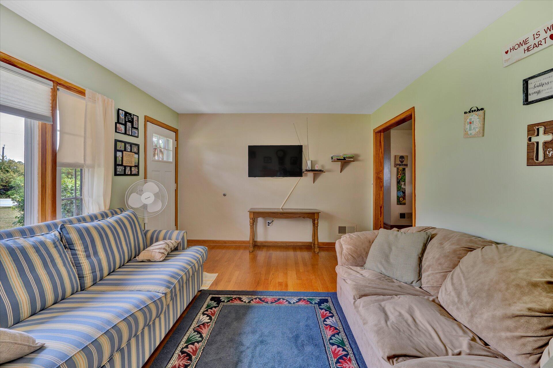 2407 White House Road Moneta, VA 24121 - Photo 10 of 52 a living room with furniture and a flat screen tv