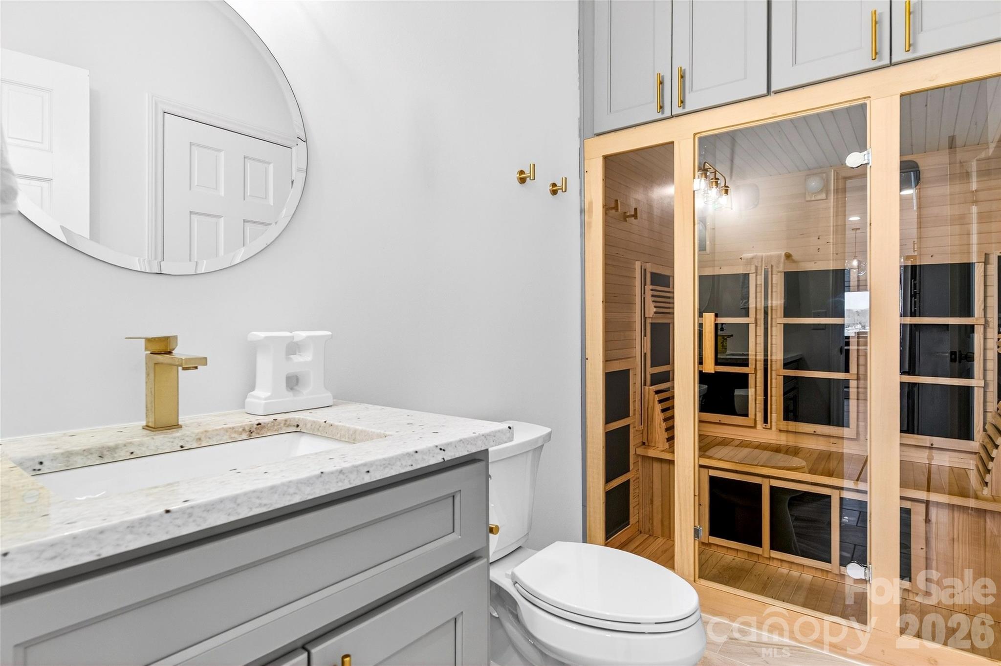 18521 Vineyard Point Lane Cornelius, NC 28031 - Photo 14 of 27 a bathroom with a granite countertop sink a toilet a mirror and shower