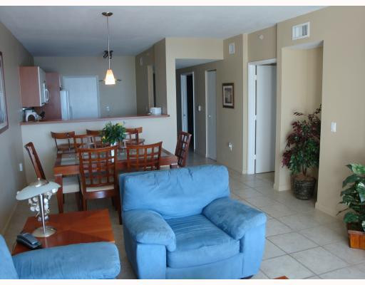 18100 North Bay Road, Unit 1006 Sunny Isles Beach, FL 33160 - Photo 3 of 8 a living room with furniture and potted plant