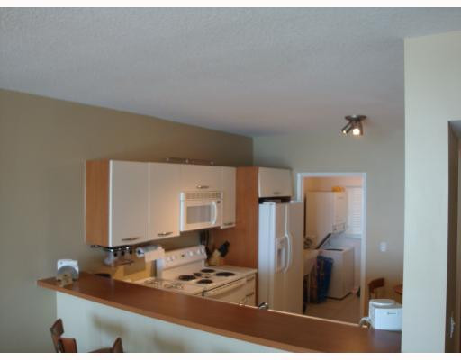 18100 North Bay Road, Unit 1006 Sunny Isles Beach, FL 33160 - Photo 4 of 8 a kitchen with a refrigerator sink and stove