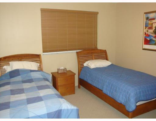 18100 North Bay Road, Unit 1006 Sunny Isles Beach, FL 33160 - Photo 6 of 8 a bedroom with a bed and a walk in closet