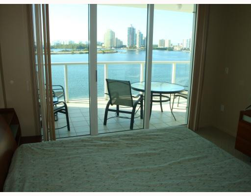 18100 North Bay Road, Unit 1006 Sunny Isles Beach, FL 33160 - Photo 7 of 8 a living room with hardwood floor and a table