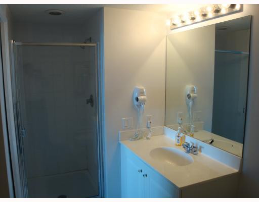 18100 North Bay Road, Unit 1006 Sunny Isles Beach, FL 33160 - Photo 8 of 8 a bathroom with a sink and mirror
