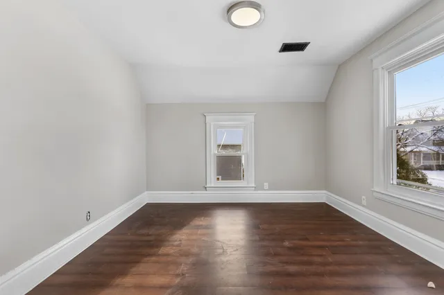 a view of wooden floor and windows in a room