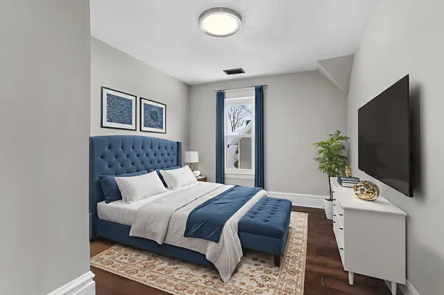 a bedroom with a bed and a flat screen tv