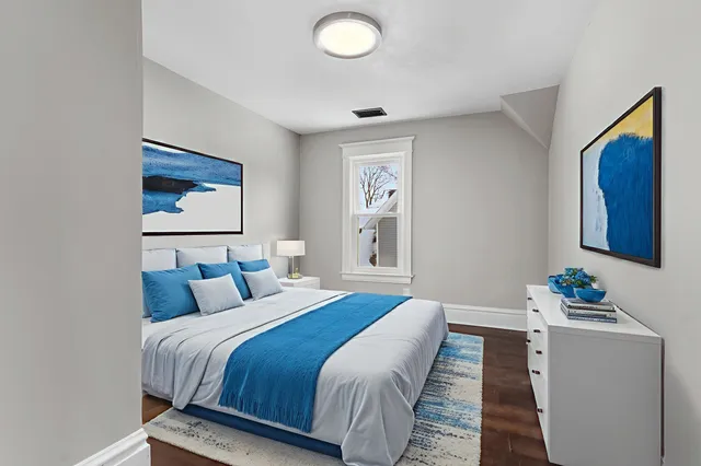 a bedroom with bed and a window