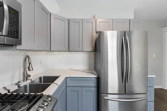 a kitchen with a refrigerator and a sink