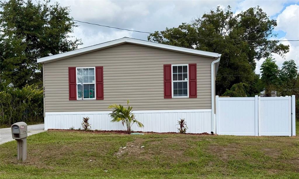 a house that has a tree in front of it