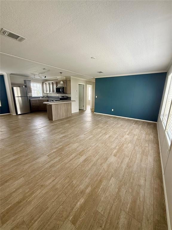 37743 Geiger Road Zephyrhills, FL 33542 - Photo 5 of 21 an empty room with wooden floor and windows