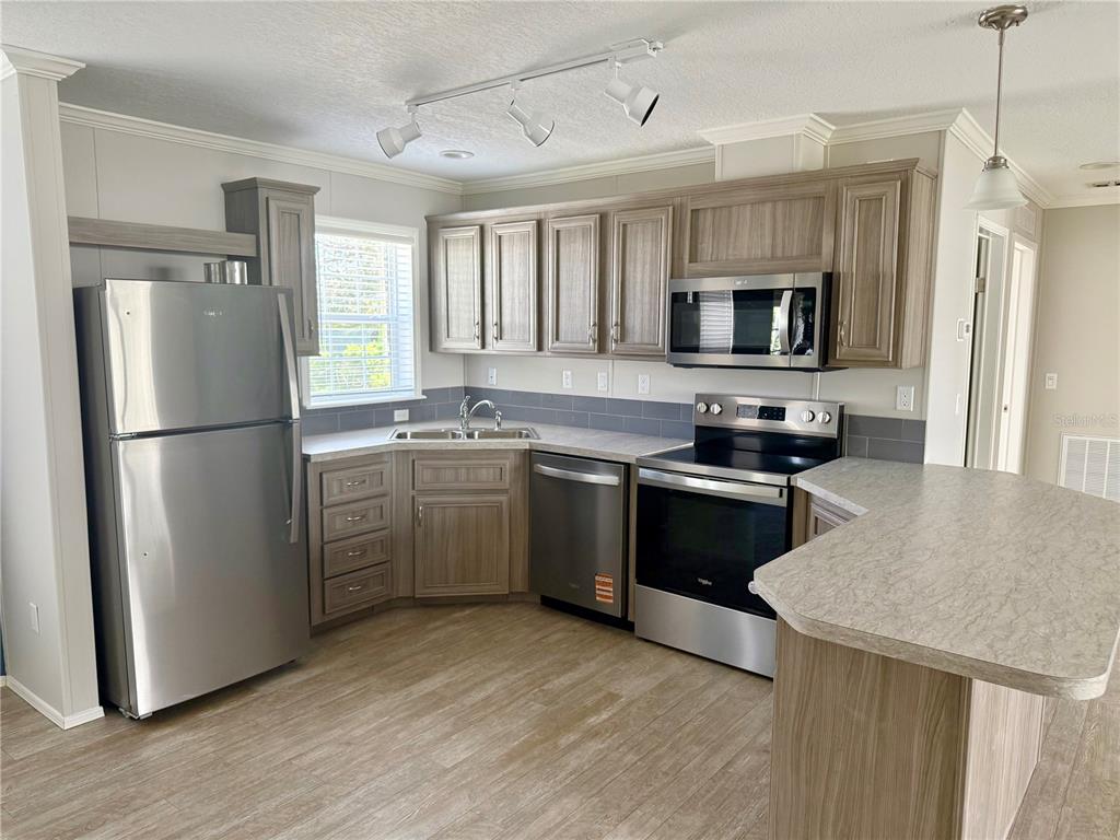 37743 Geiger Road Zephyrhills, FL 33542 - Photo 9 of 21 a kitchen with a sink appliances and cabinets