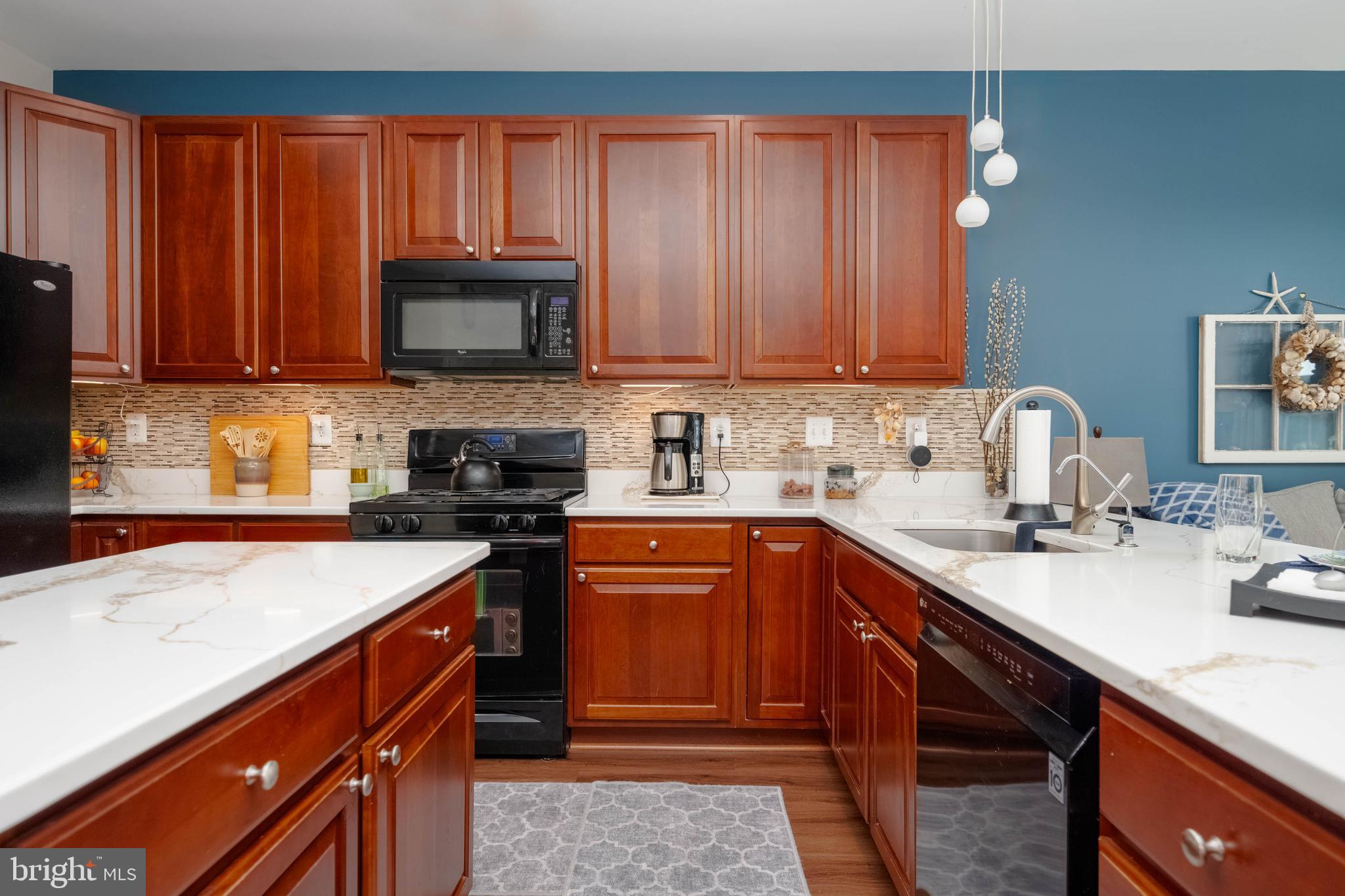 3107 Raking Leaf Drive Abingdon, MD 21009 - Photo 10 of 39 a kitchen with granite countertop a sink stove and cabinets