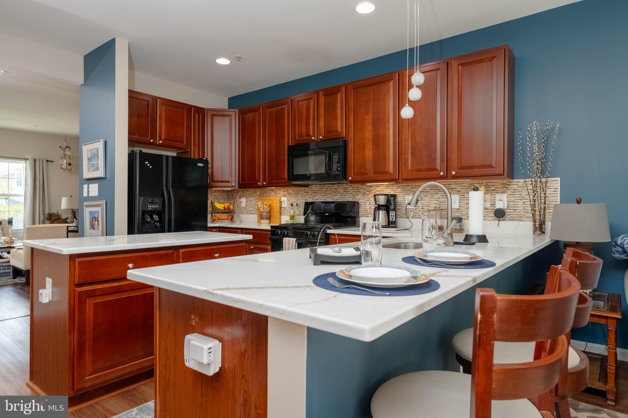 3107 Raking Leaf Drive Abingdon, MD 21009 - Photo 11 of 39 a kitchen with a sink a stove and chairs