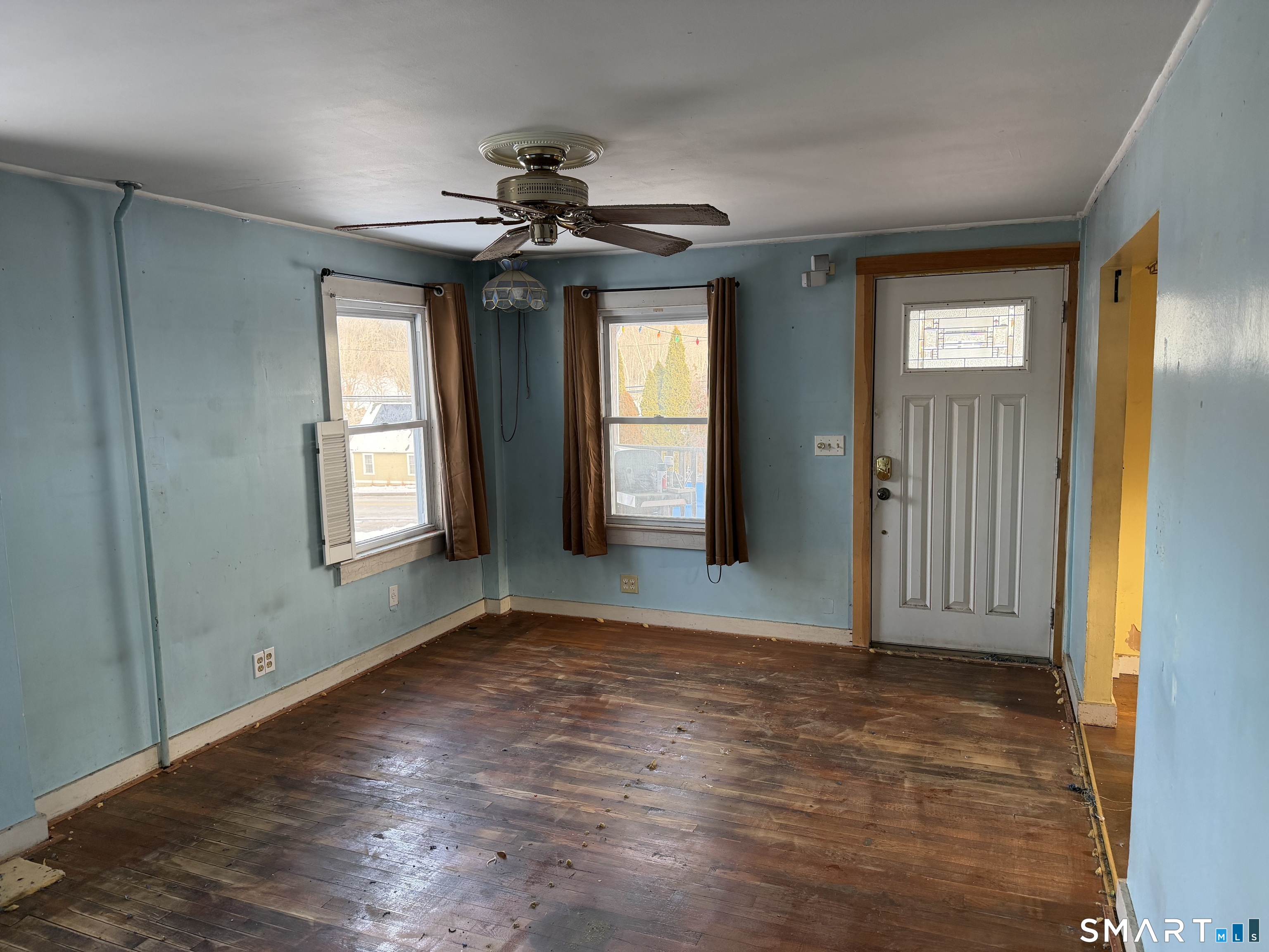 292 Old Colchester Road Montville, CT 06382 - Photo 11 of 18 an empty room with chandelier fan and windows