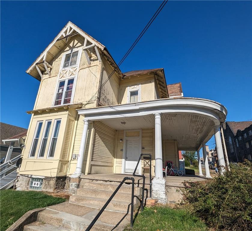 300 Jackson Street Rochester, PA 15074 - Photo 1 of 10 a view of a brick house with large windows and a table