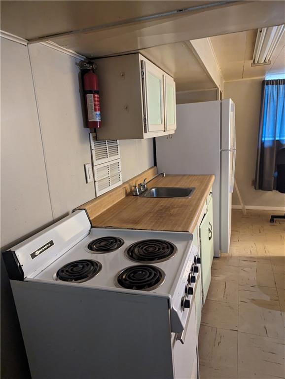 300 Jackson Street Rochester, PA 15074 - Photo 3 of 10 a kitchen with a stove and a refrigerator