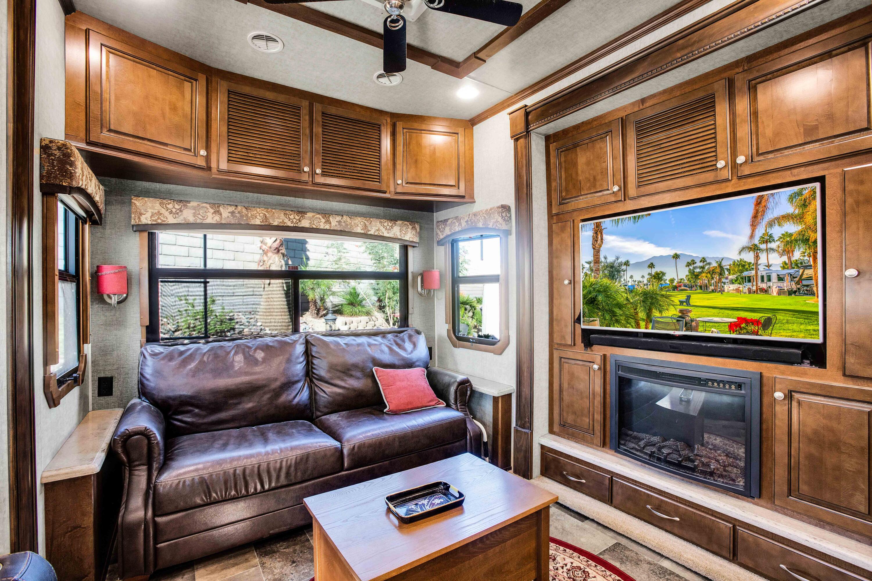 69411 Ramon Road, Unit 131 Cathedral City, CA 92234 - Photo 12 of 65 a living room with furniture a flat screen tv and a floor to ceiling window