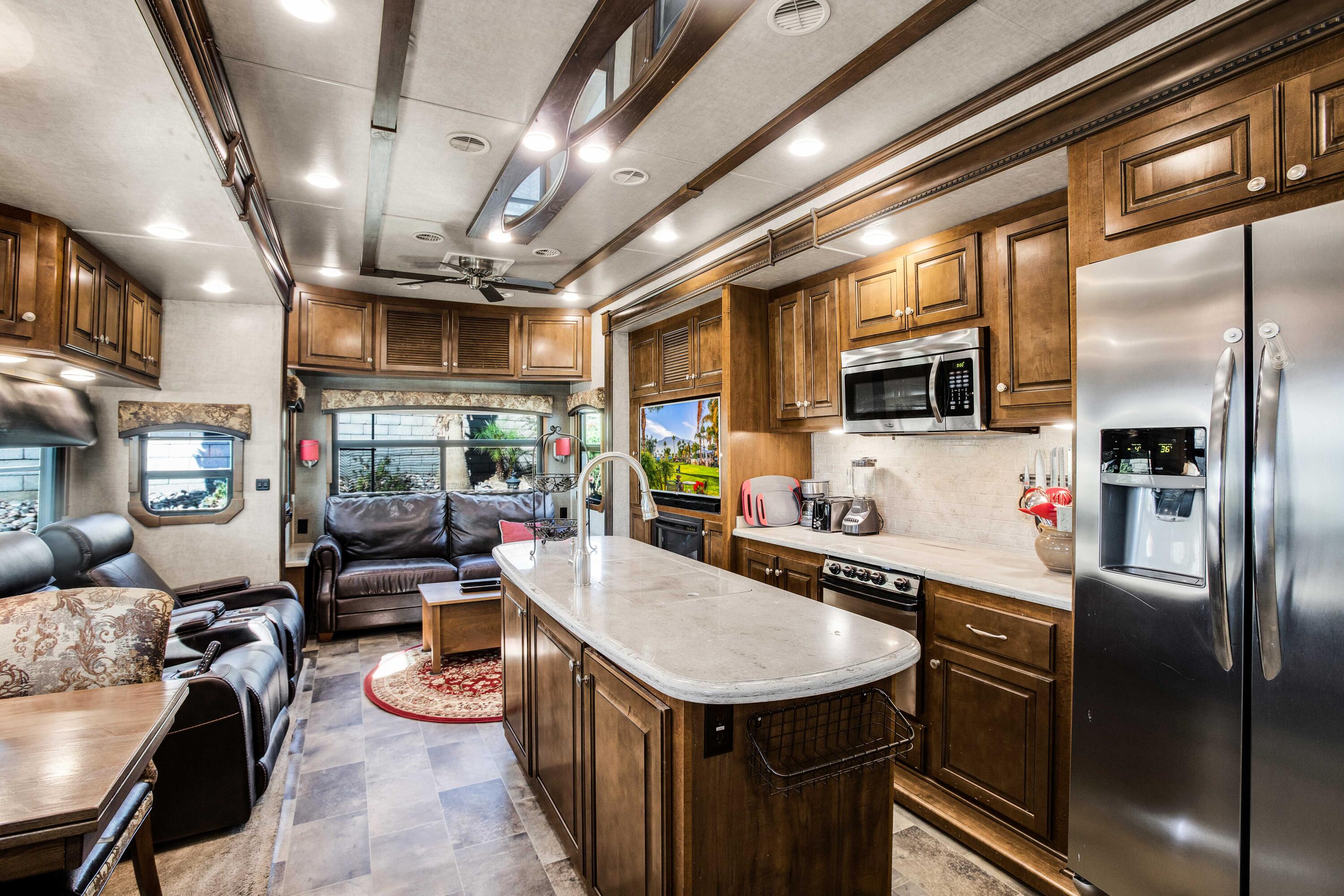 69411 Ramon Road, Unit 131 Cathedral City, CA 92234 - Photo 3 of 65 a kitchen with stainless steel appliances granite countertop a sink a stove and a refrigerator