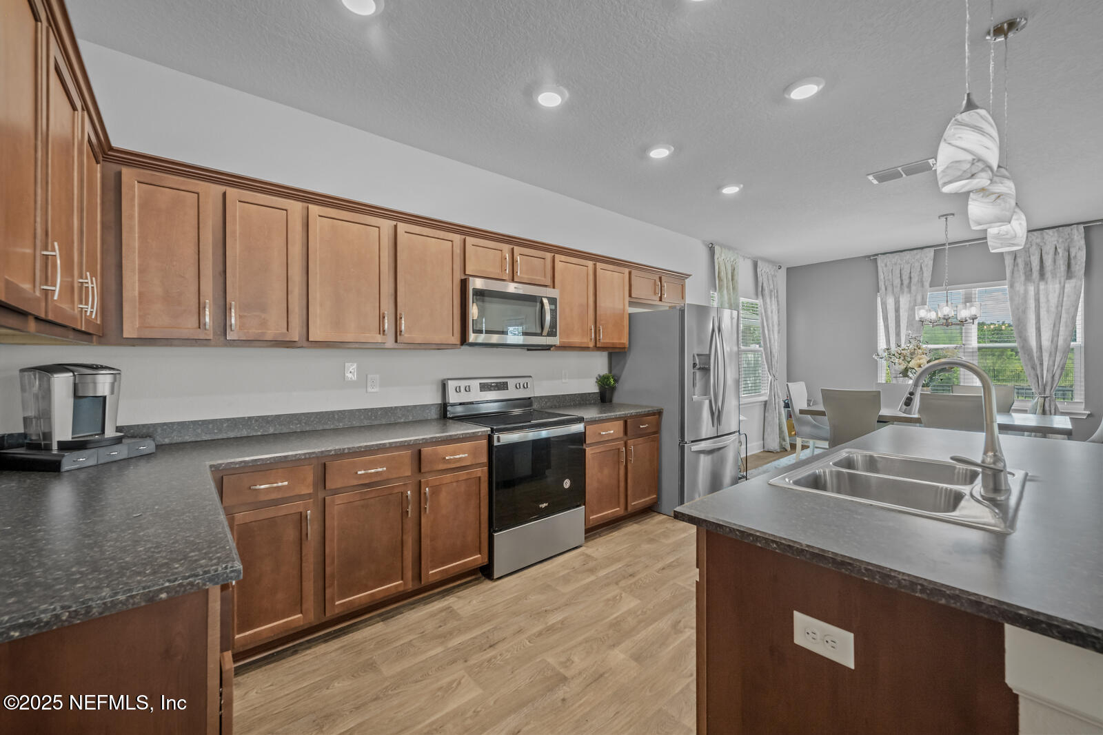 9961 Redfish Marsh Circle Jacksonville, FL 32219 - Photo 12 of 37 a kitchen with stainless steel appliances granite countertop a sink stove and refrigerator