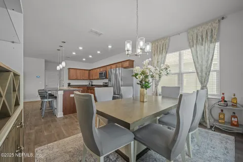 a view of a dining room with furniture and a chandelier