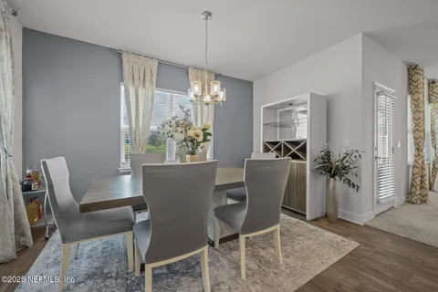 a view of a dining room with furniture and chandelier