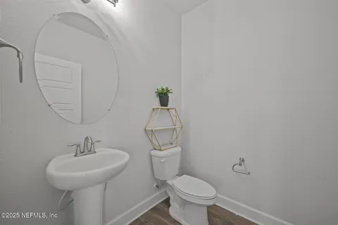 a bathroom with a toilet a sink and mirror