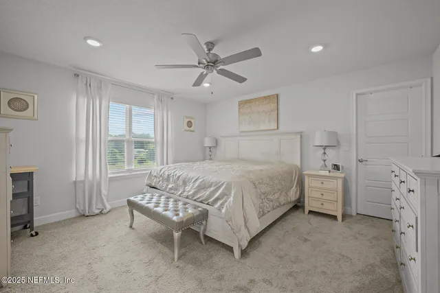a spacious bedroom with a bed and a chandelier