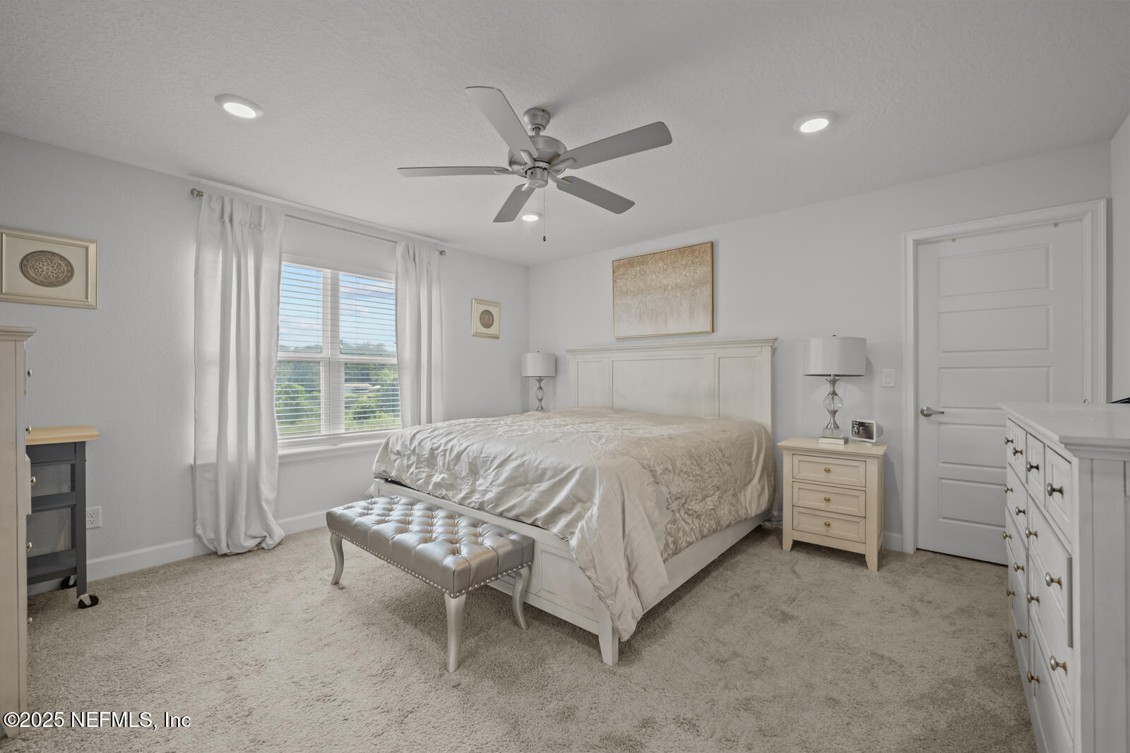 9961 Redfish Marsh Circle Jacksonville, FL 32219 - Photo 20 of 37 a spacious bedroom with a bed and a chandelier