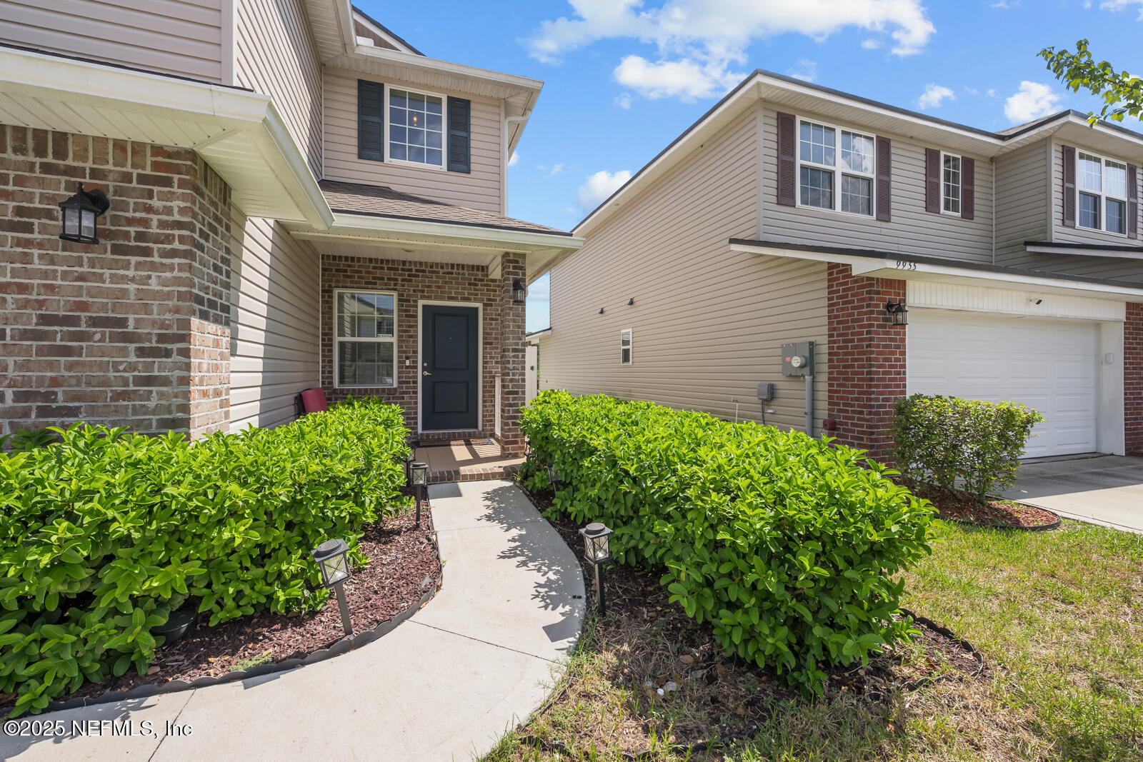 9961 Redfish Marsh Circle Jacksonville, FL 32219 - Photo 2 of 37 a front view of a house with garden