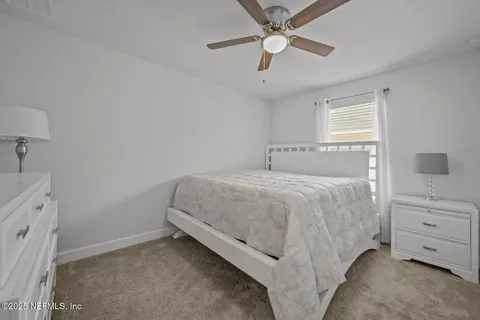 a spacious bedroom with a bed and a cabinets