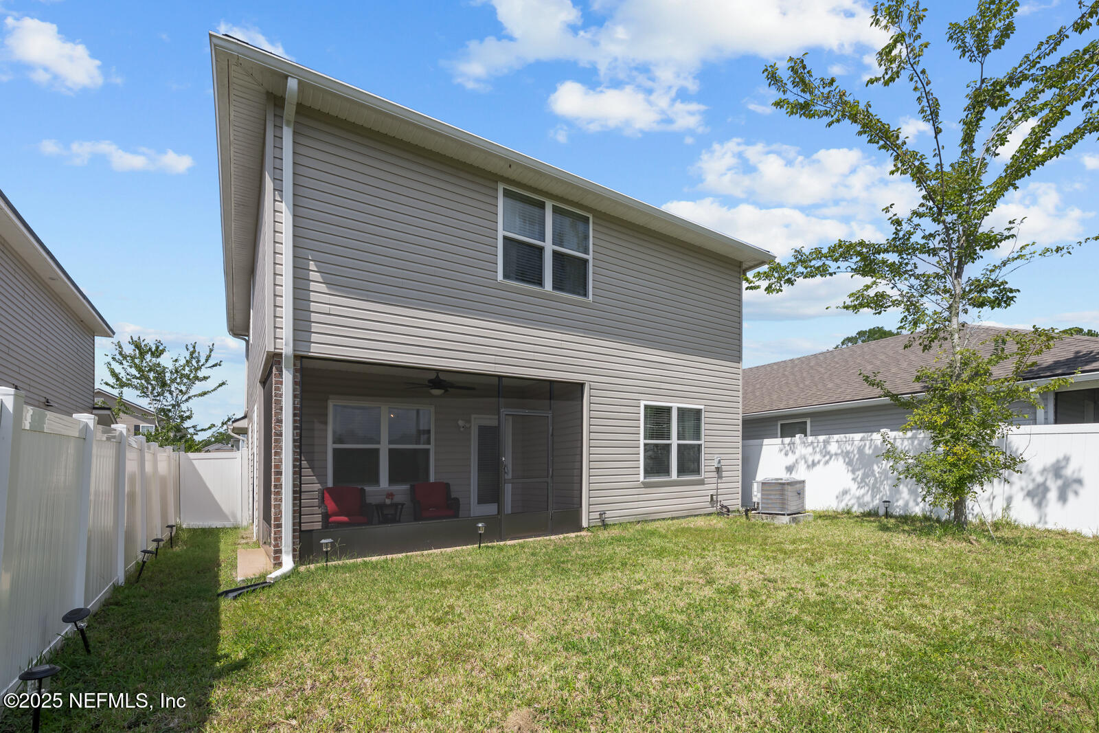 9961 Redfish Marsh Circle Jacksonville, FL 32219 - Photo 31 of 37 a view of a house with brick walls and a yard with plants
