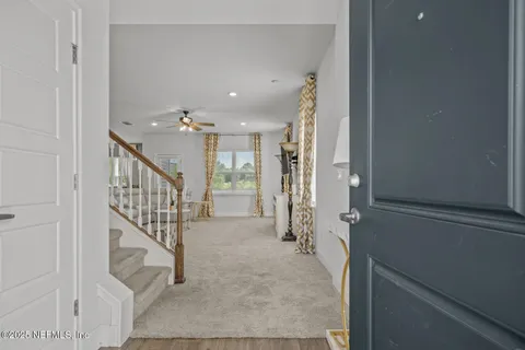 a view of a hallway with wooden floor and entryway